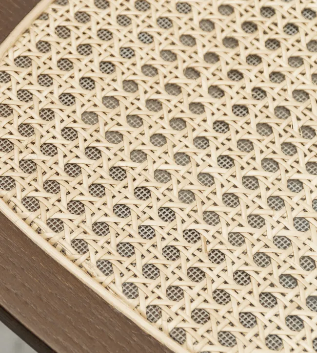 Close-up of Titus dining chair by Vincent Sheppard, with oak frame and finely handwoven natural cane seat.