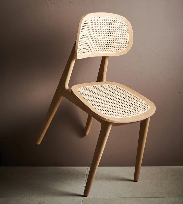 Titus dining chair by Vincent Sheppard, crafted in oak with a handwoven cane backrest and slender, curved wooden frame.