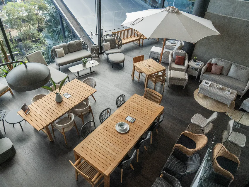 Cotswold Furniture showroom in Alexandria, Sydney, featuring a spacious, well-lit interior with classic and contemporary outdoor furniture displays, including wicker chairs, wooden dining sets, and decorative cushions arranged in styled room settings.