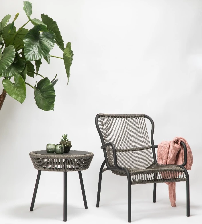 Loop Lounge chair by Vincent Sheppard with a fossil grey metal frame and woven rope design, paired with a matching round side table. 