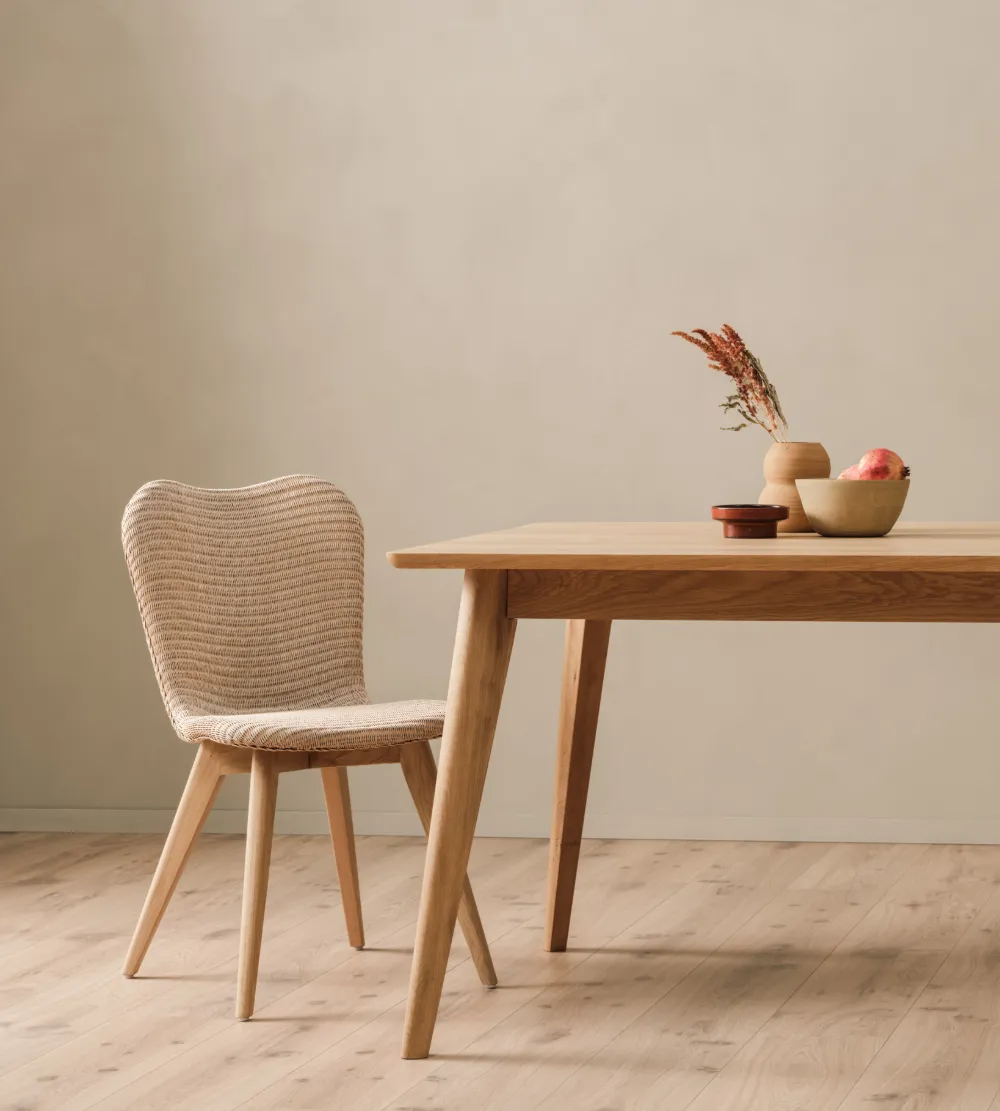 Lily Dining chair by Vincent Sheppard in White Wash finish with an oak base, placed beside a matching wood dining table in a calm, minimalist setting.