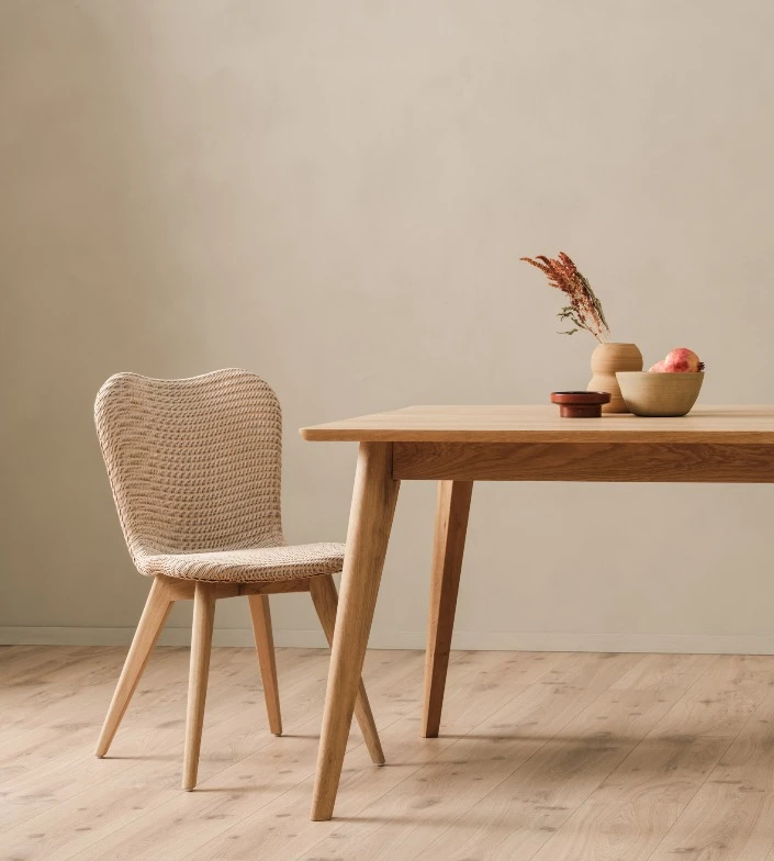 Lily Dining chair by Vincent Sheppard in White Wash finish with an oak base, placed beside a matching wood dining table in a calm, minimalist setting.